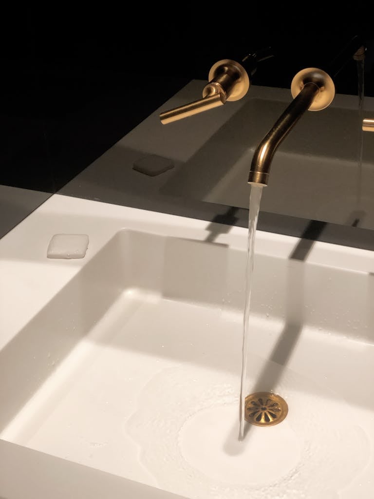 Water Flowing from Bronze Colored Faucet